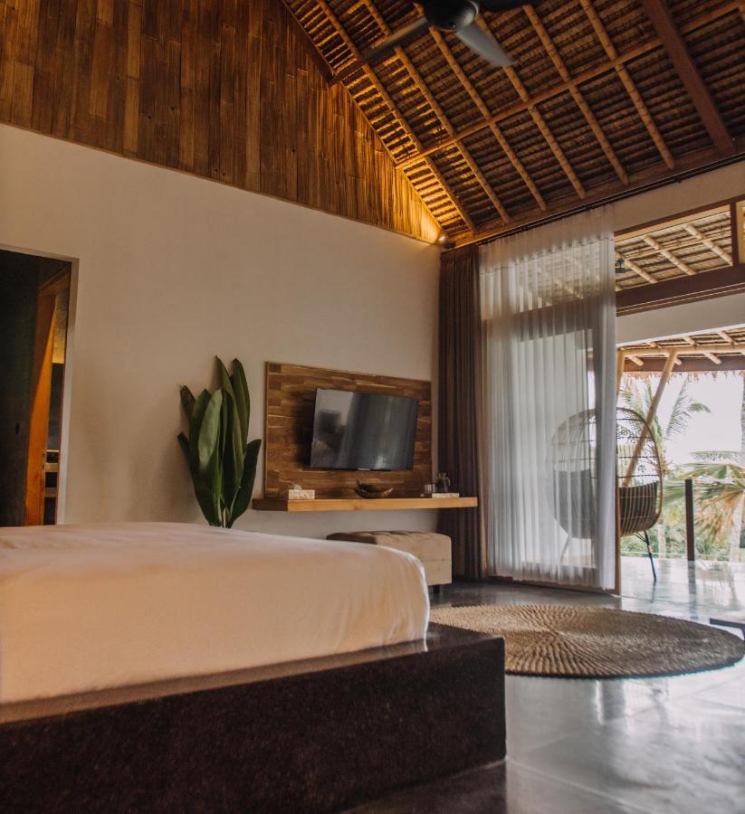 Neano Escape Hotel Manggis Exterior foto A bedroom at the resort
